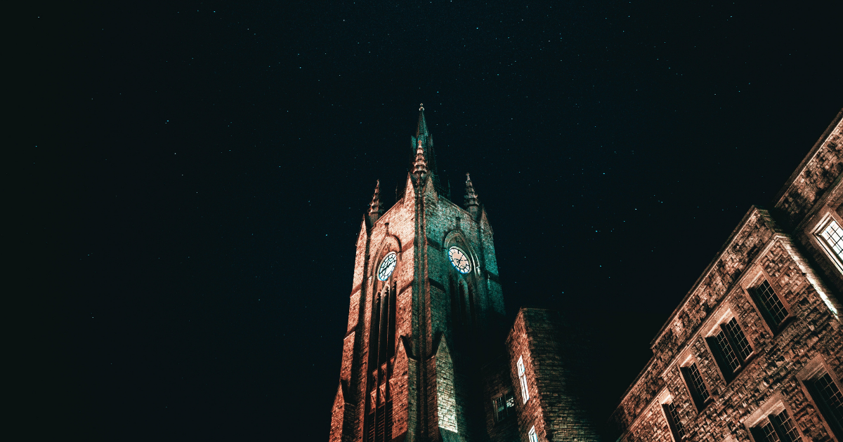A photo of Middlesex College at night with a starry sky.